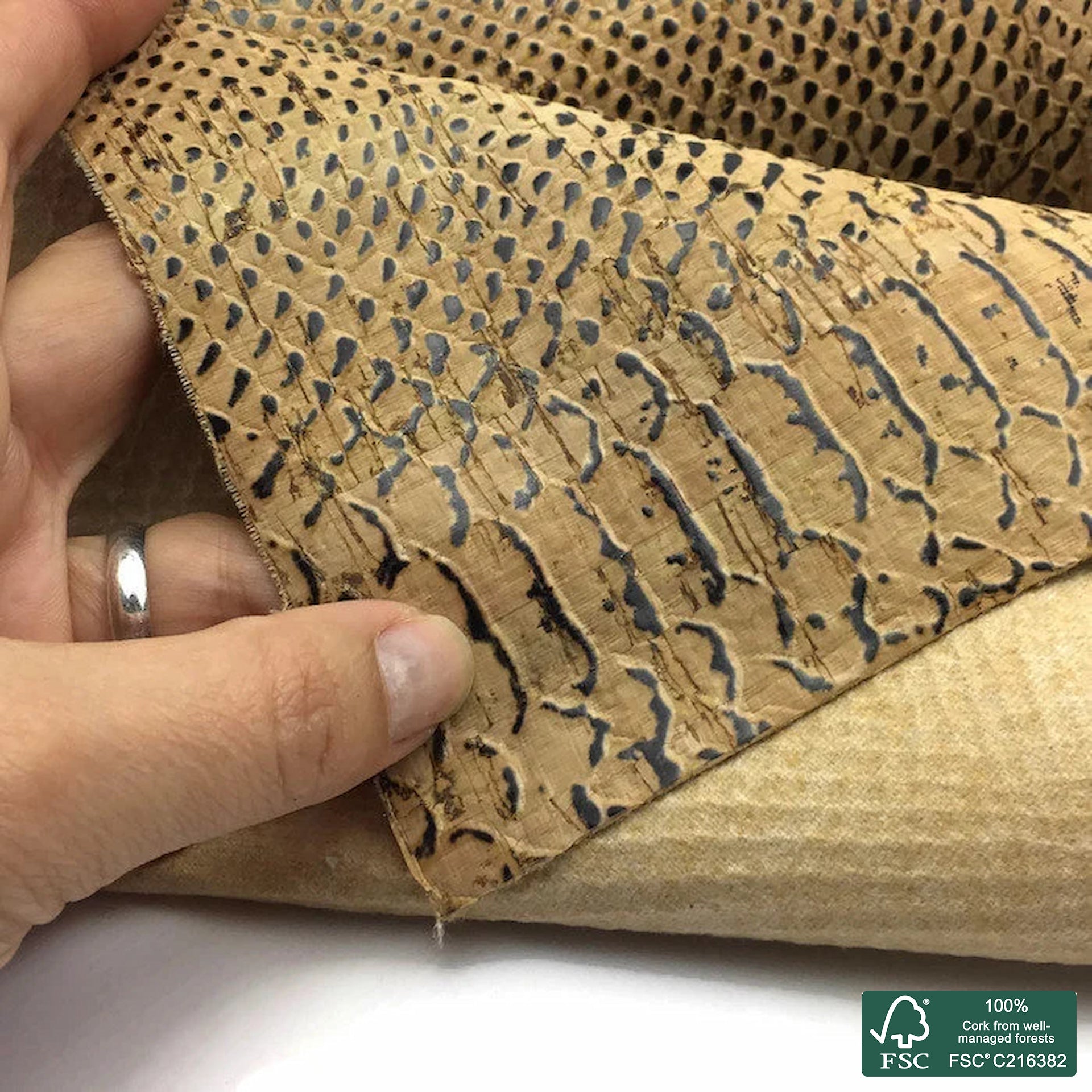 Piton embossed on natural rustic cork fabric